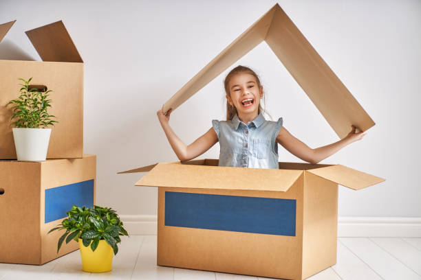 Child Girl In The House With A Symbol Of Roof. Concept Of Housing For Family.